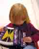 [Lucy playing accordion]